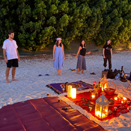 Participants standing beside lanterns at dusk