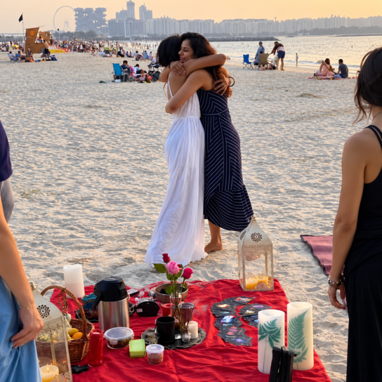 Two women embracing on a beach