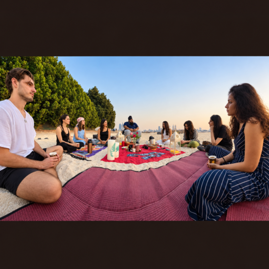 Group seated together in a circle on a beach