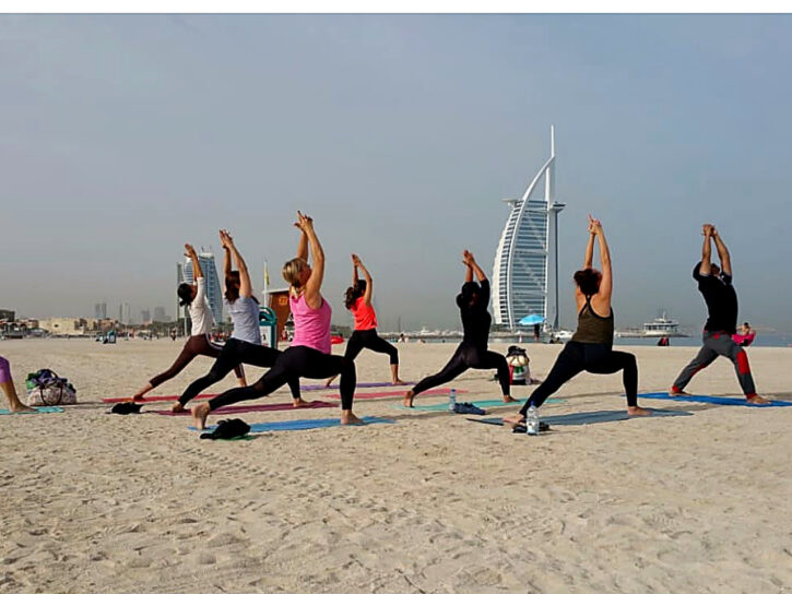 Outdoor group yoga session near the shore