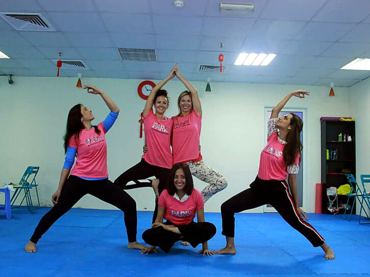 Participants demonstrating yoga in a studio