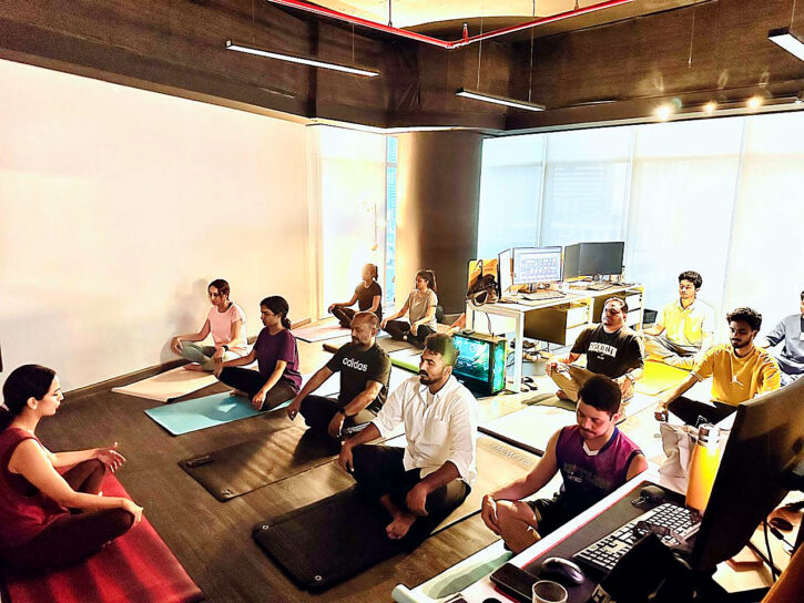 Participants taking part in a yoga class at their workplace