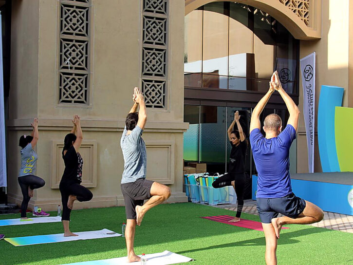 Participants holding standing balance poses outdoors